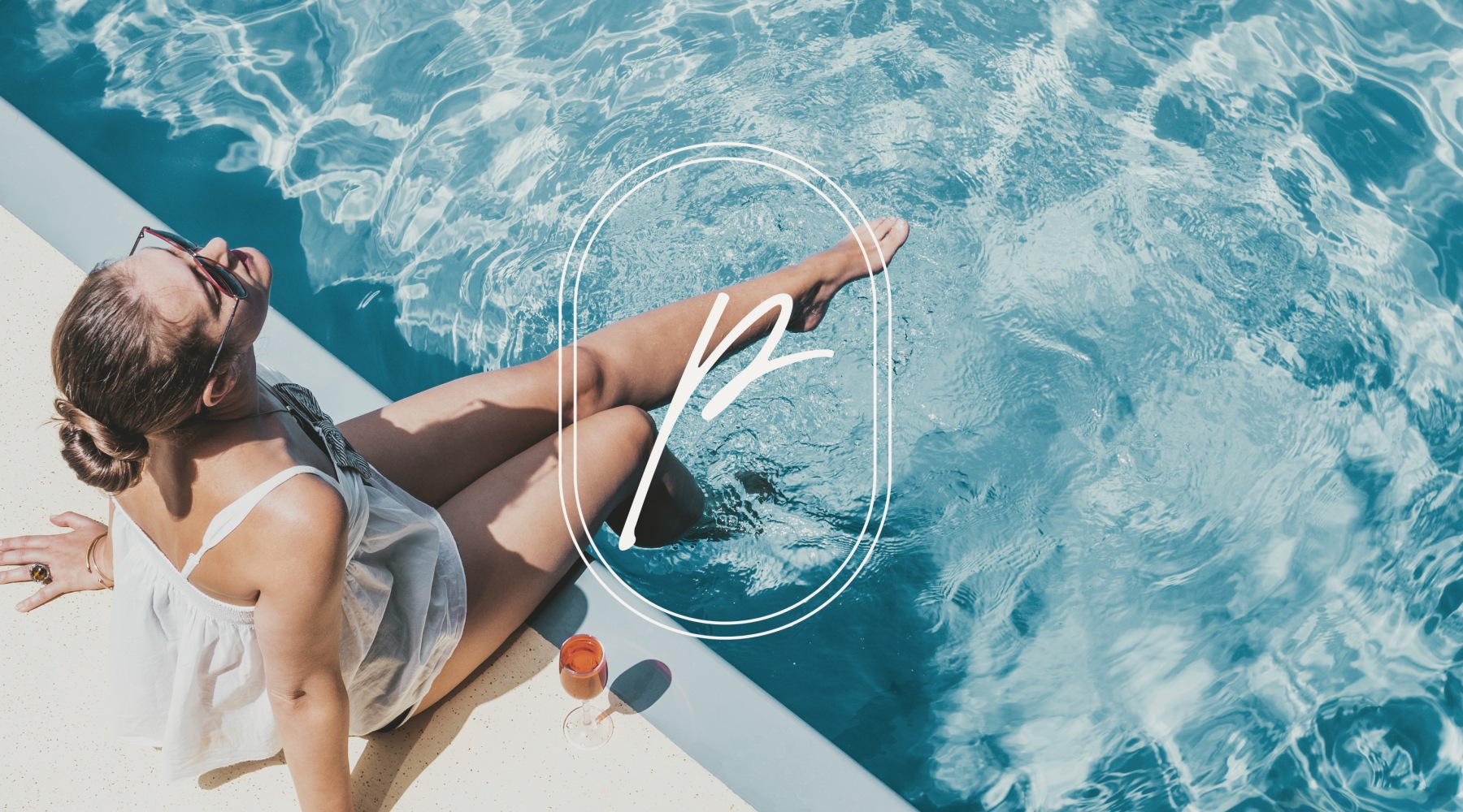 a woman sitting with legs dipped in blue pool water